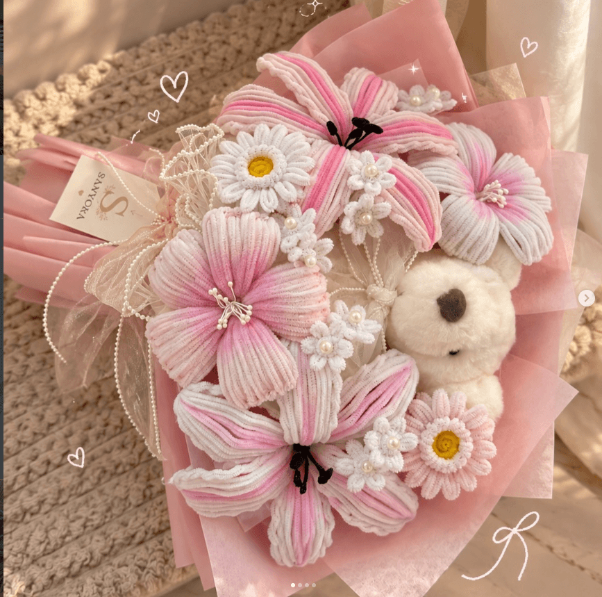 A bouquet of blush crochet lilies and pearl daisies
